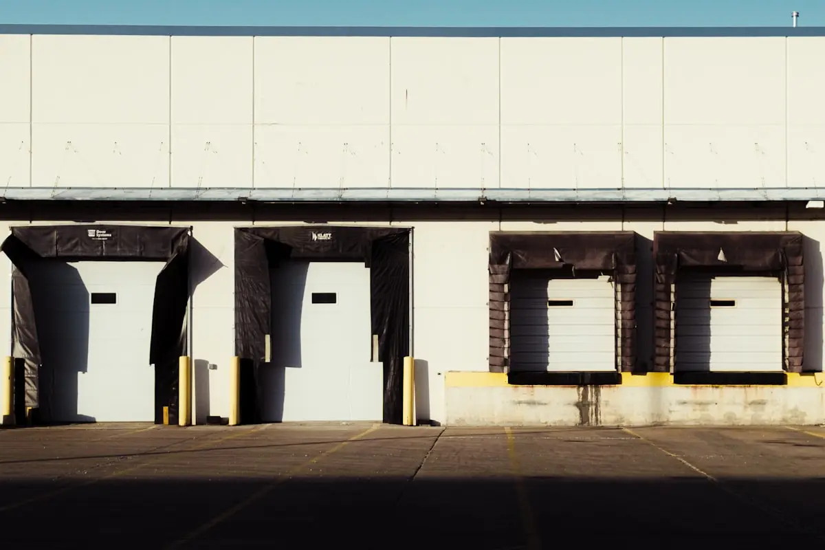 Row of commercial loading dock bay doors — commercial door service by Casp3r, DFW